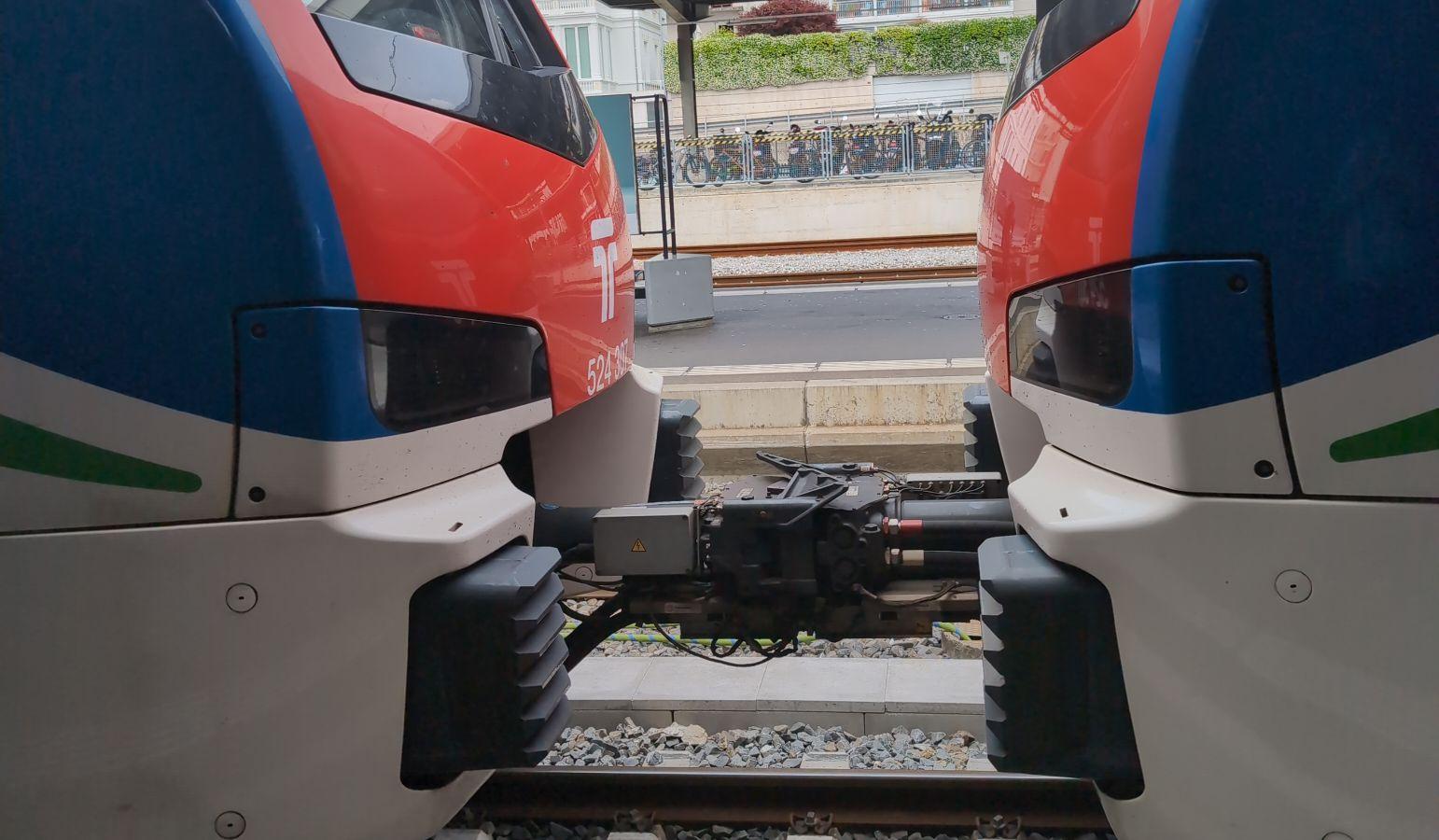 close up of 2 Stadler FLIRT 160 Trains with TILO livery kissing (they are coupled together)